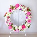 Soft pink and lilac round wreath with white stand