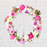 Soft pink and lilac round wreath with white stand